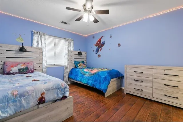 a bedroom with a bed and a dresser