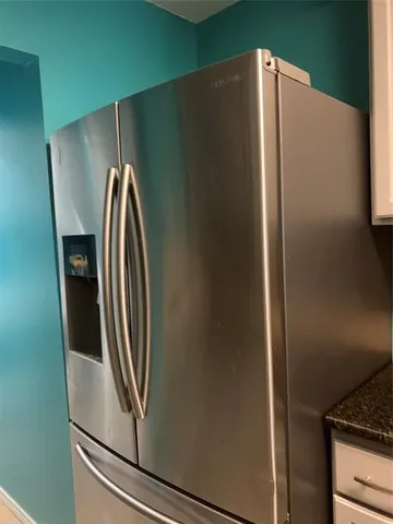 a view of a refrigerator in kitchen