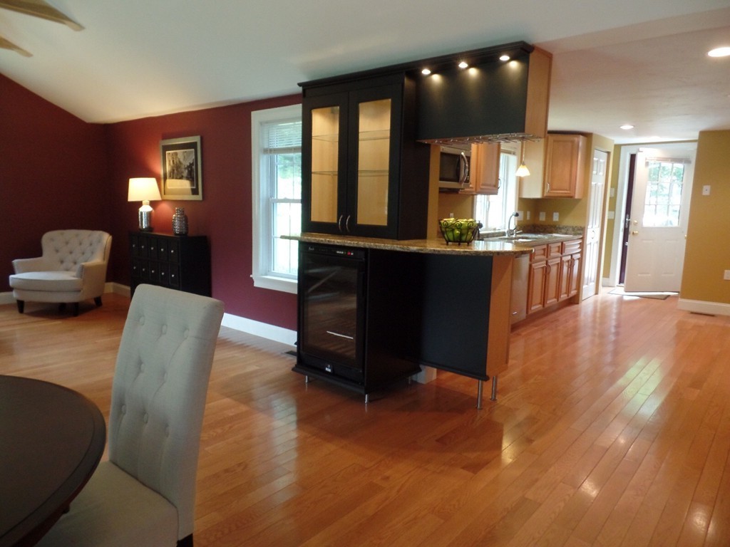 234 Stonebridge Road Wayland, MA 01778 - Photo 1 of 20 a living room with couches and kitchen view with wooden floor