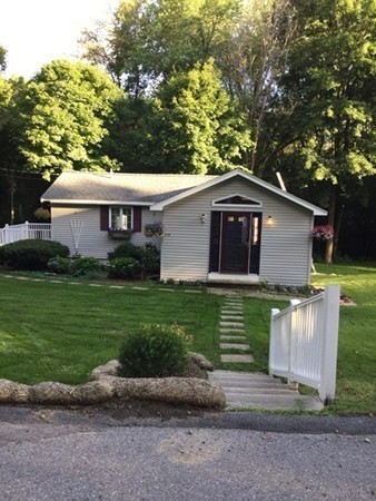 234 Stonebridge Road Wayland, MA 01778 - Photo 20 of 20 a front view of a house with a garden