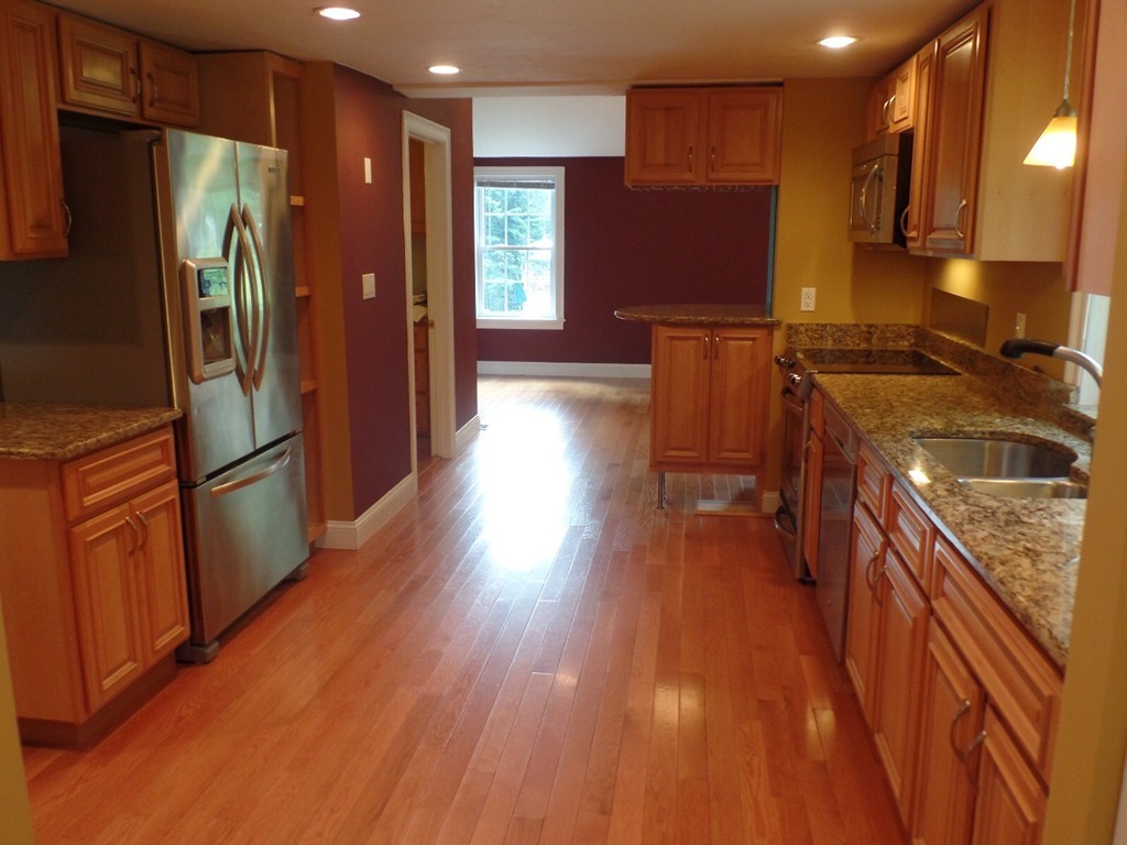 234 Stonebridge Road Wayland, MA 01778 - Photo 4 of 20 a kitchen with stainless steel appliances granite countertop a refrigerator a stove and a wooden floors
