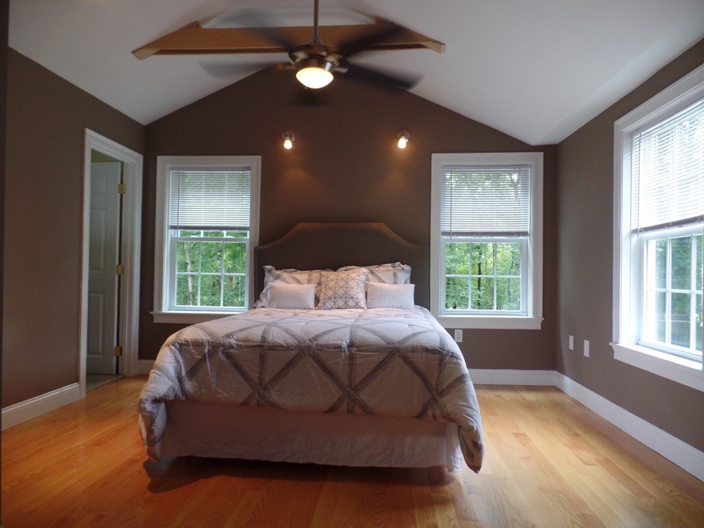 234 Stonebridge Road Wayland, MA 01778 - Photo 9 of 20 a spacious bedroom with a bed and a window