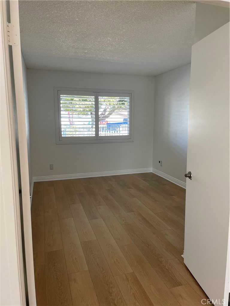 601 Hunter Street Oceanside, CA 92058 - Photo 11 of 14 an empty room with wooden floor and windows