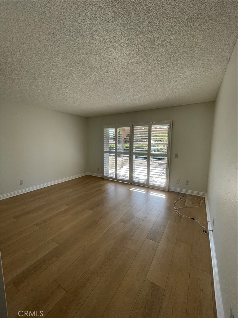 601 Hunter Street Oceanside, CA 92058 - Photo 13 of 14 an empty room with wooden floor and windows