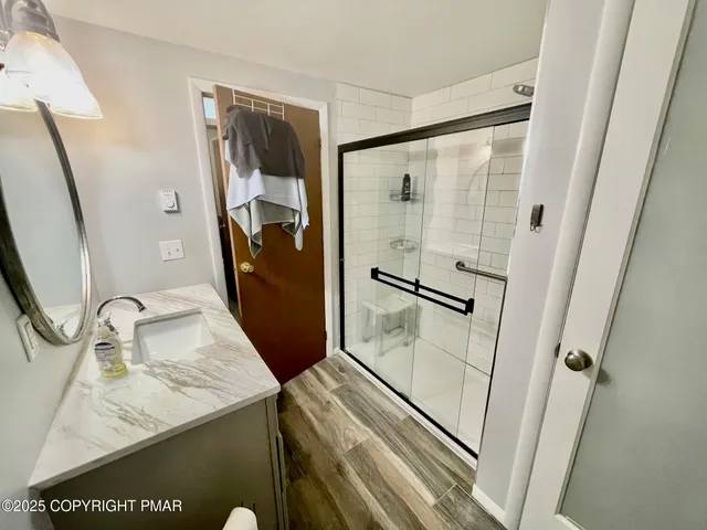 a bathroom with a granite countertop sink vanity and mirror