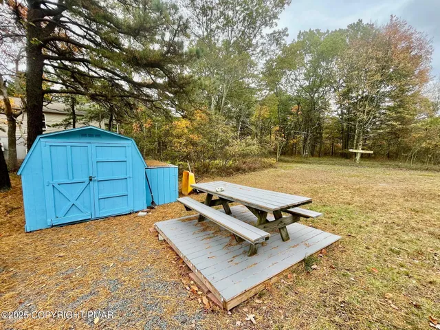 a view of a backyard with chairs