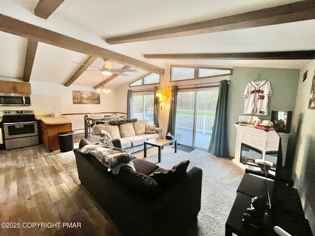 a living room with furniture fireplace and a flat screen tv