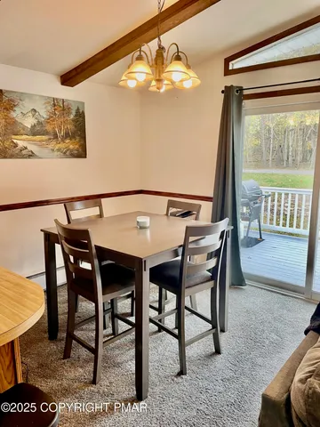 a view of a dining room with furniture and a window