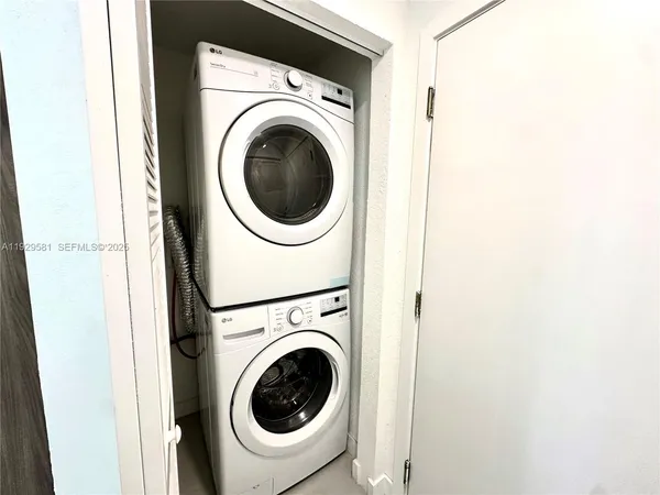 a view of a hallway with washer and dryer