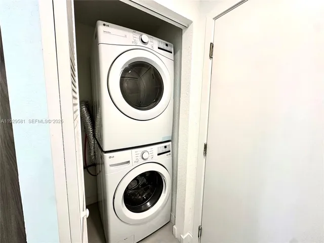 a view of a hallway with washer and dryer