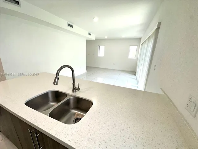 a bathroom with a sink a toilet a mirror and shower