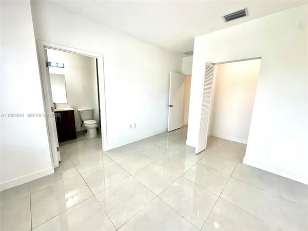 a bathroom with a toilet a sink and a mirror