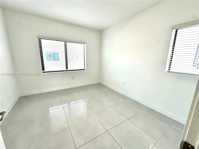 a bathroom with a tub shower and a sink