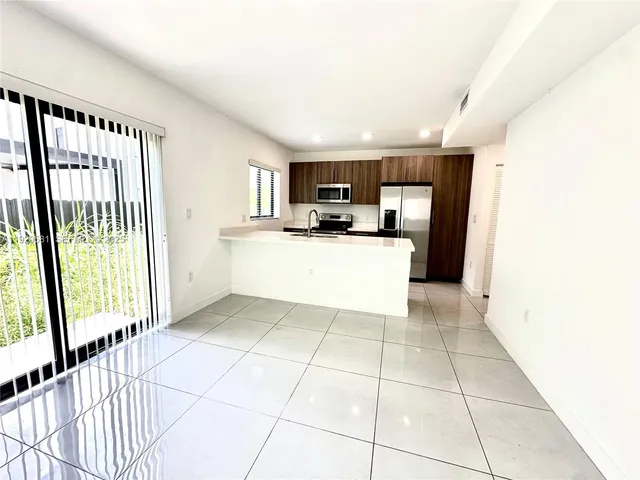 a kitchen with a sink a counter top space and cabinets