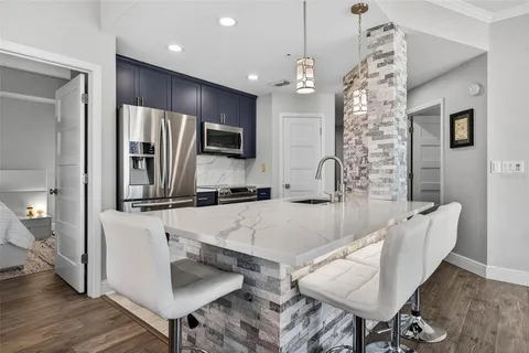 a large kitchen with a table and chairs