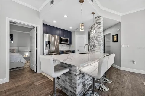 a living room with furniture a chandelier and a wooden floor