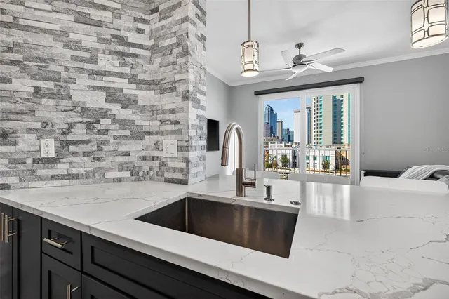 a kitchen with a sink and a stove with granite countertops