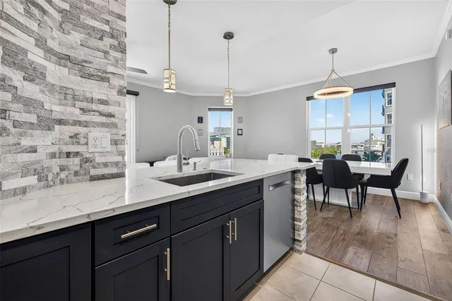 a kitchen with a sink dining table and chairs
