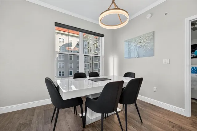 a view of a dining room with a table and chairs