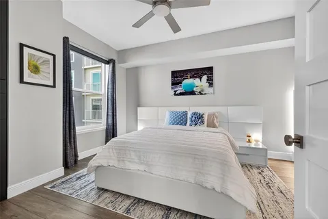 a bedroom with a large bed and a chandelier