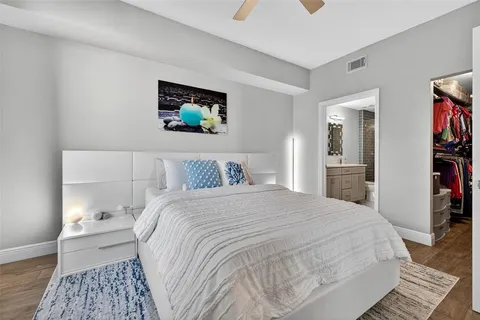 a bedroom with a bed and a view of kitchen