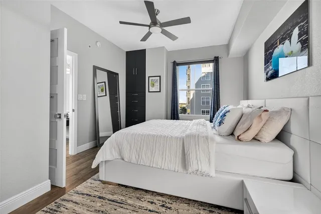 a bedroom with a large bed and a chandelier