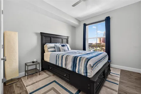 a bed sitting in a bedroom next to a window