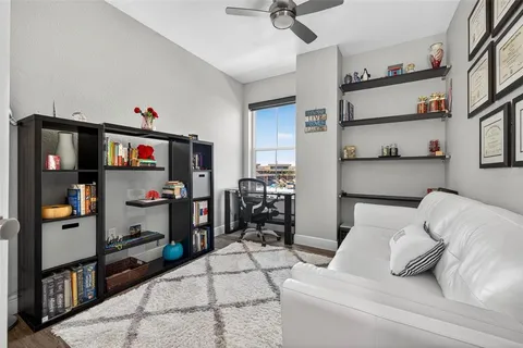 a bedroom with bed and a book shelf