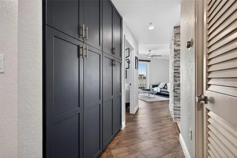 a view of a hallway with a livingroom and furniture