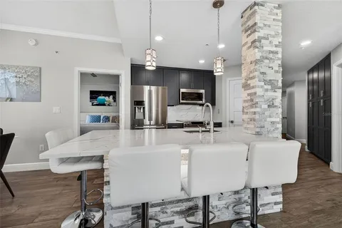 a large kitchen with a table and chairs