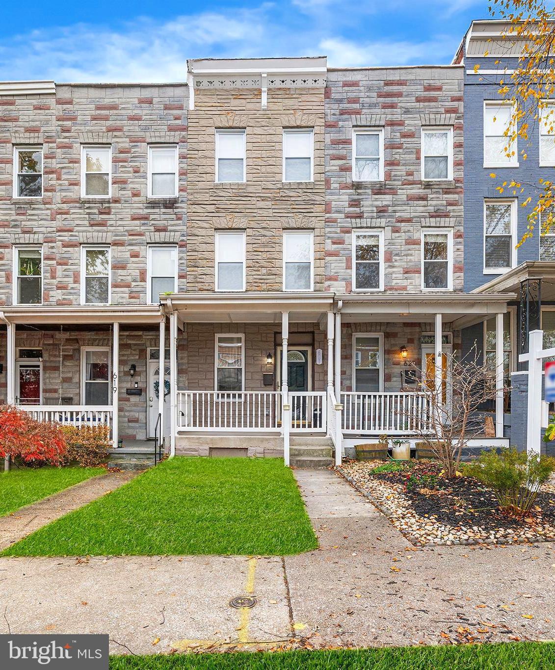 front view of a brick house with a yard