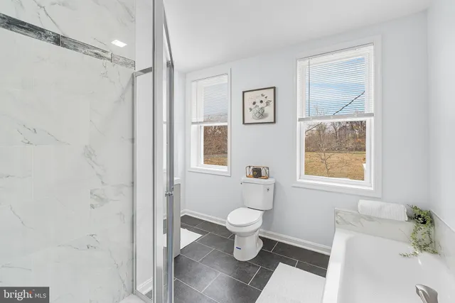 a bathroom with a toilet and a shower