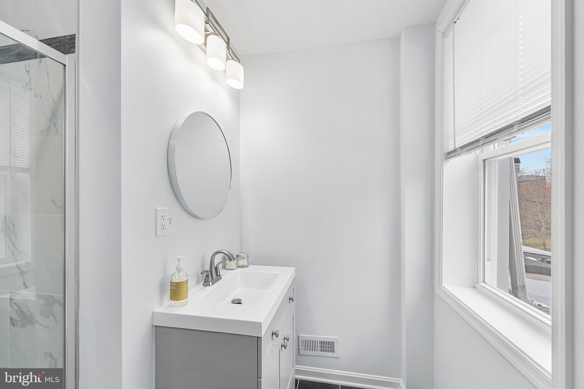 621 West 33rd Street Baltimore, MD 21211 - Photo 15 of 27 a bathroom with a sink and a mirror