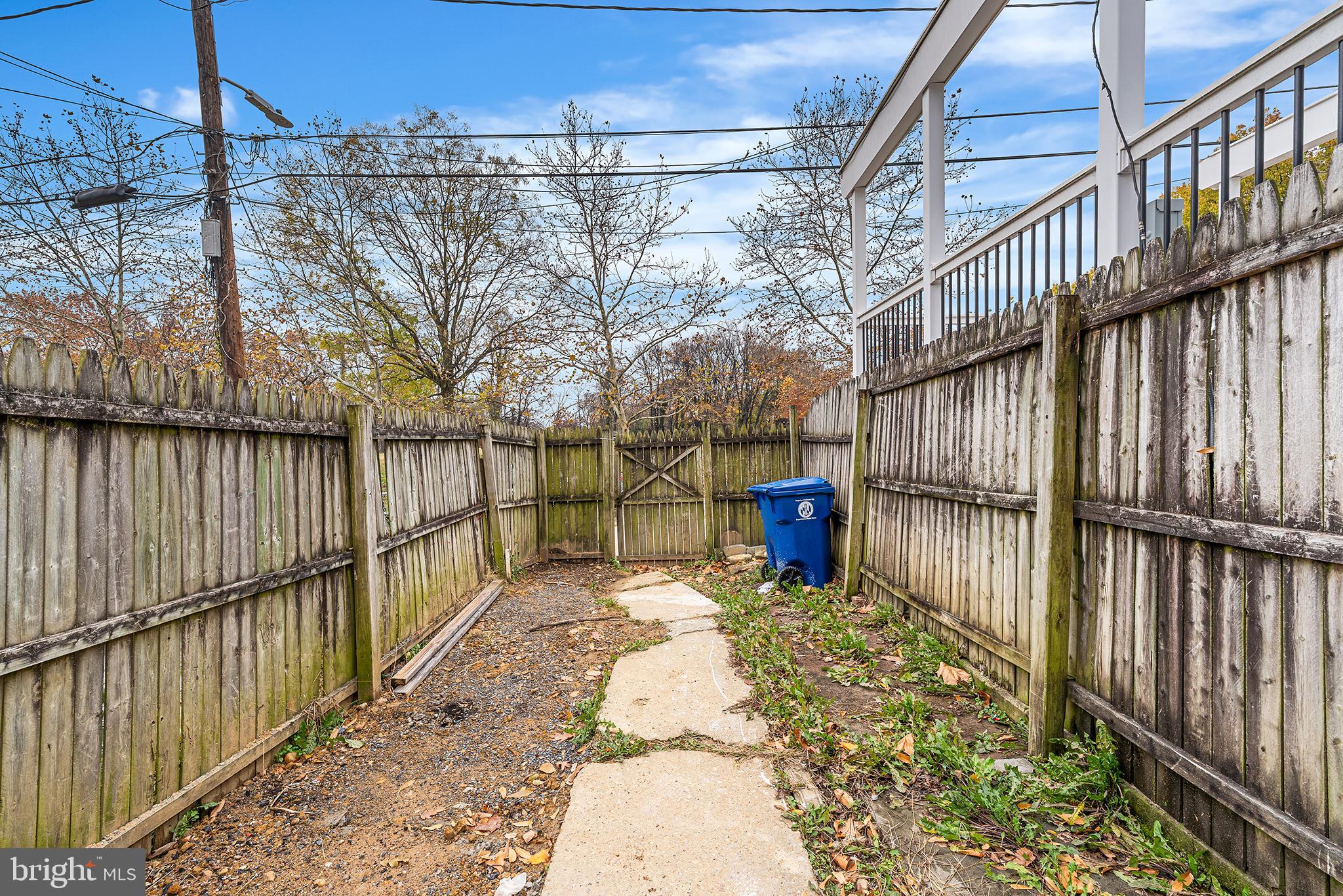 621 West 33rd Street Baltimore, MD 21211 - Photo 22 of 27 a view of a backyard with a large tree and wooden fence