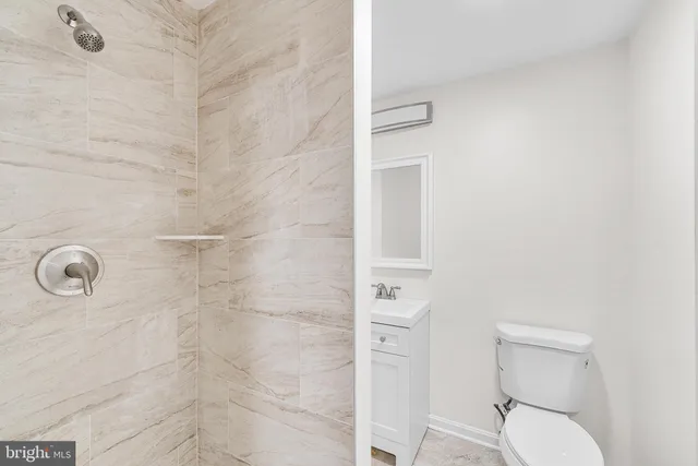 a bathroom with a toilet and a shower