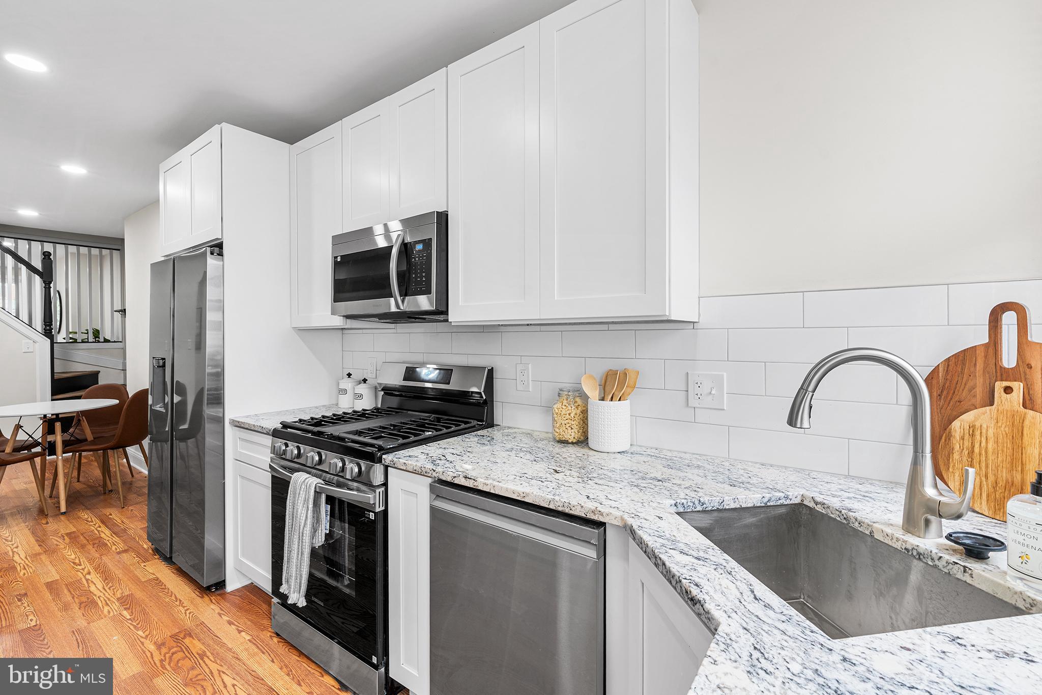 621 West 33rd Street Baltimore, MD 21211 - Photo 7 of 27 a kitchen with stainless steel appliances granite countertop a sink stove and cabinets