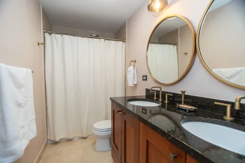a bathroom with a double vanity sink and a mirror