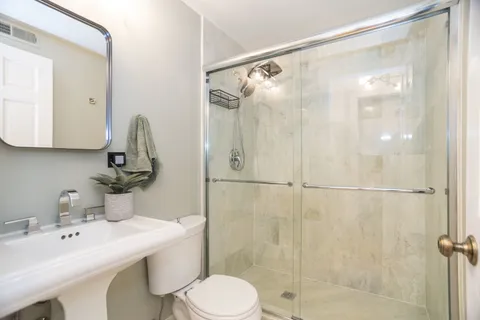 a bathroom with a sink toilet and shower