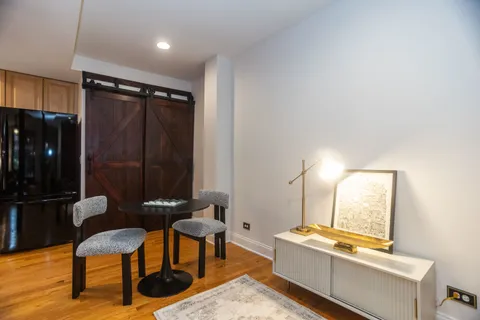 a room with furniture wall paintings and a window