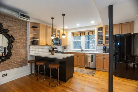 a kitchen with granite countertop a sink appliances and cabinets