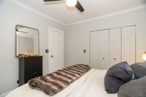 a bedroom with a bed and ceiling fan