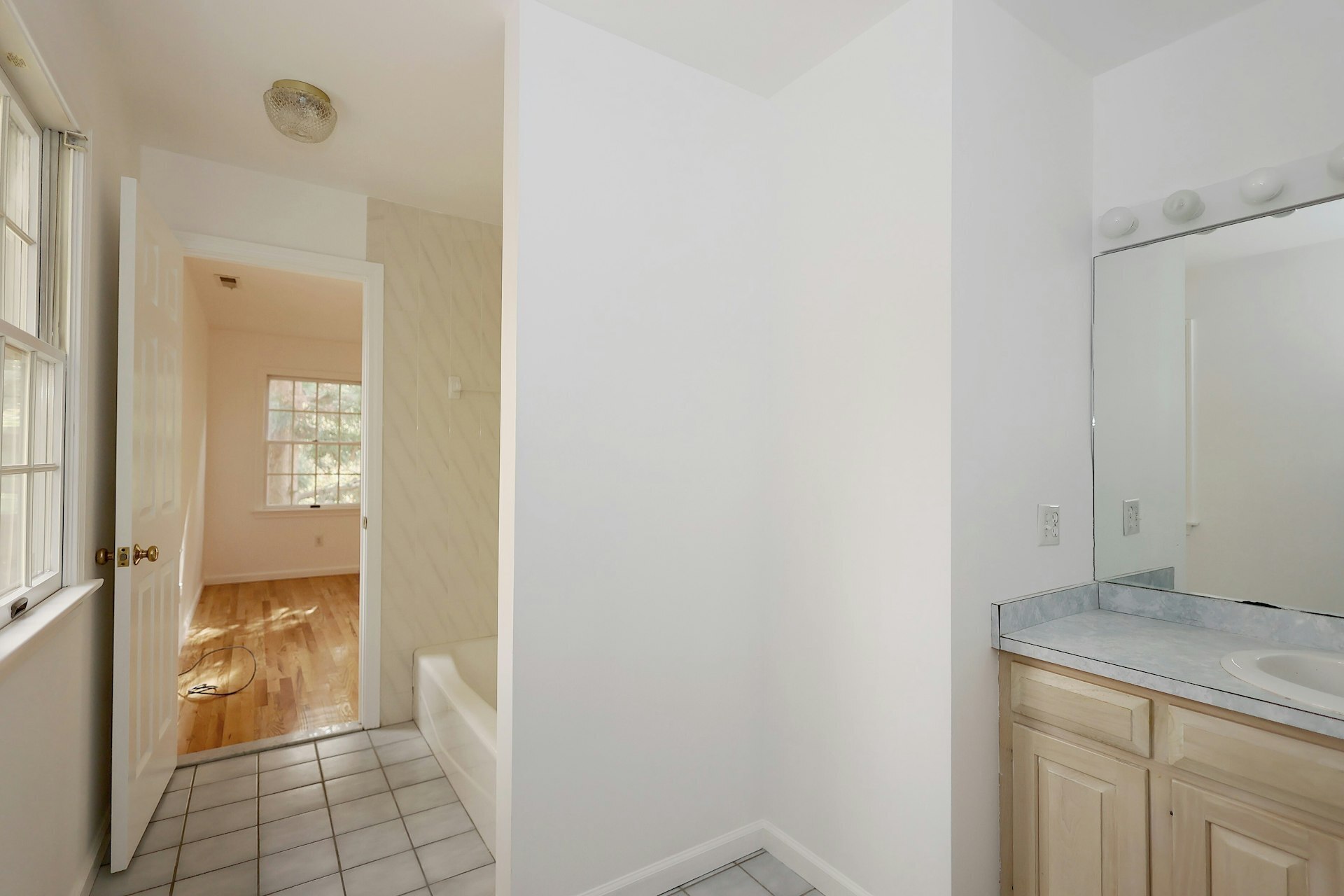 44 Deer Run Road Fairfield, CT 06824 - Photo 12 of 40 a view of a hallway with wooden floor and a bathroom