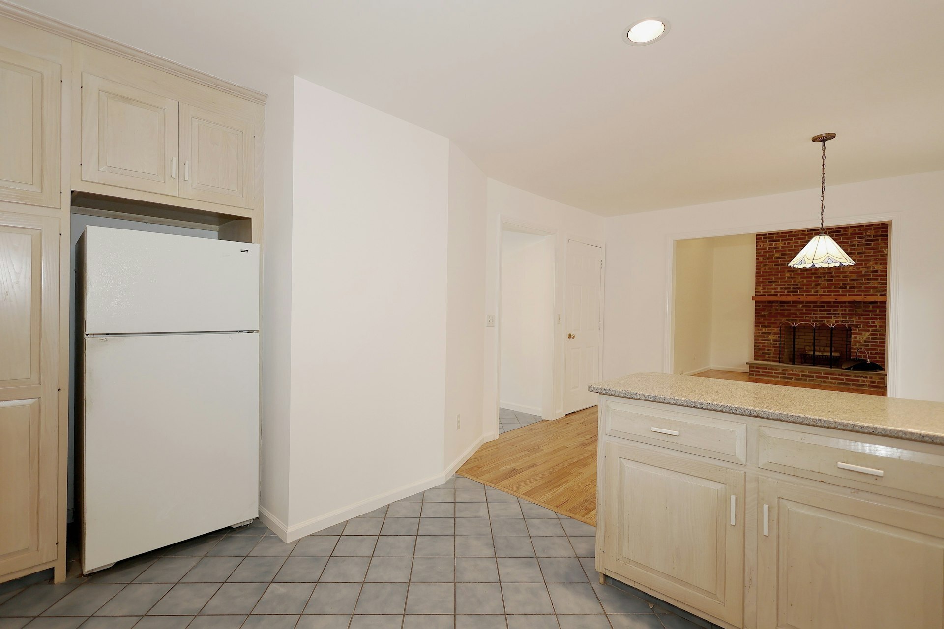 44 Deer Run Road Fairfield, CT 06824 - Photo 29 of 40 a kitchen with white cabinets and a refrigerator