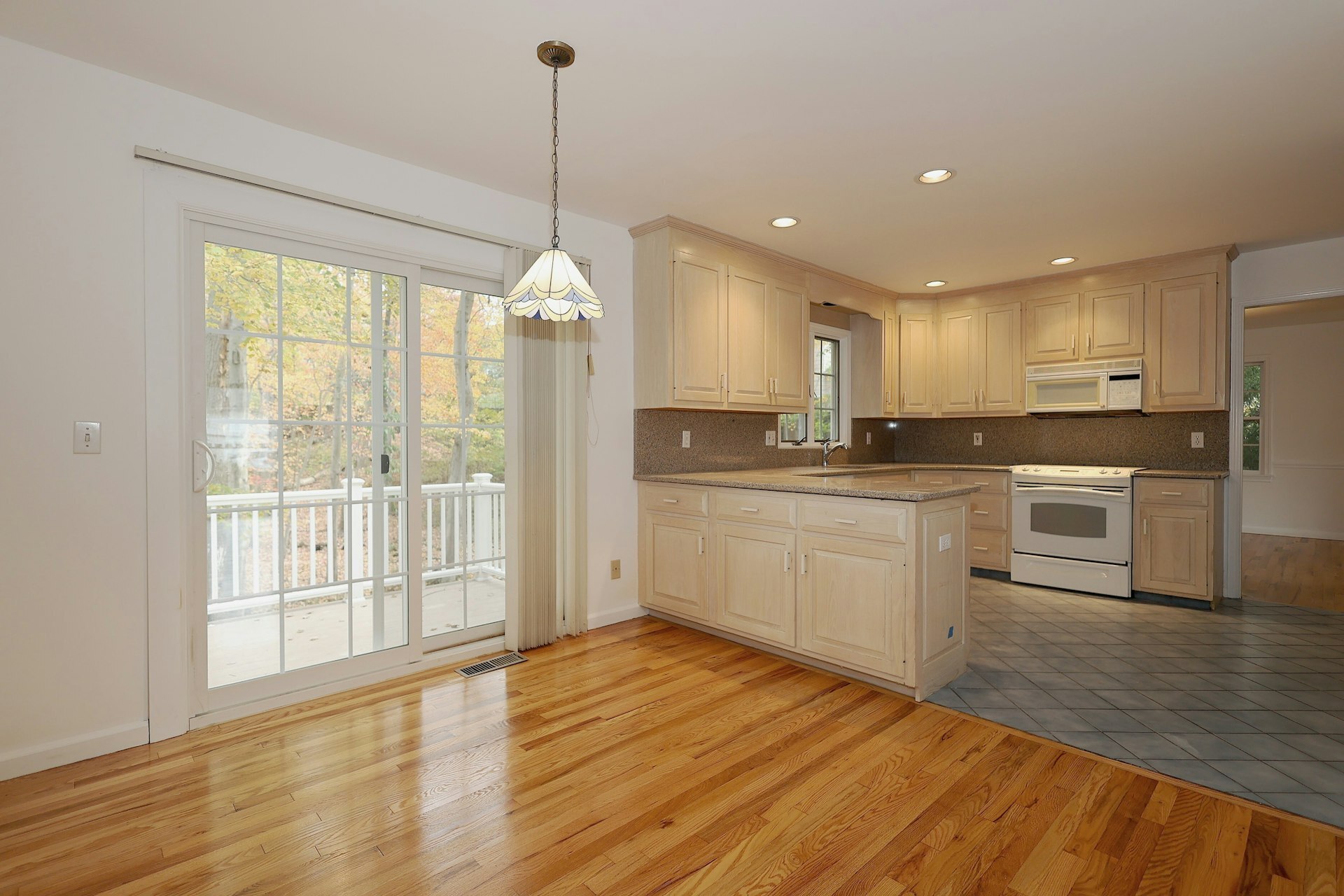 44 Deer Run Road Fairfield, CT 06824 - Photo 31 of 40 a kitchen with stainless steel appliances granite countertop a stove a sink dishwasher a refrigerator and white cabinets with wooden floor