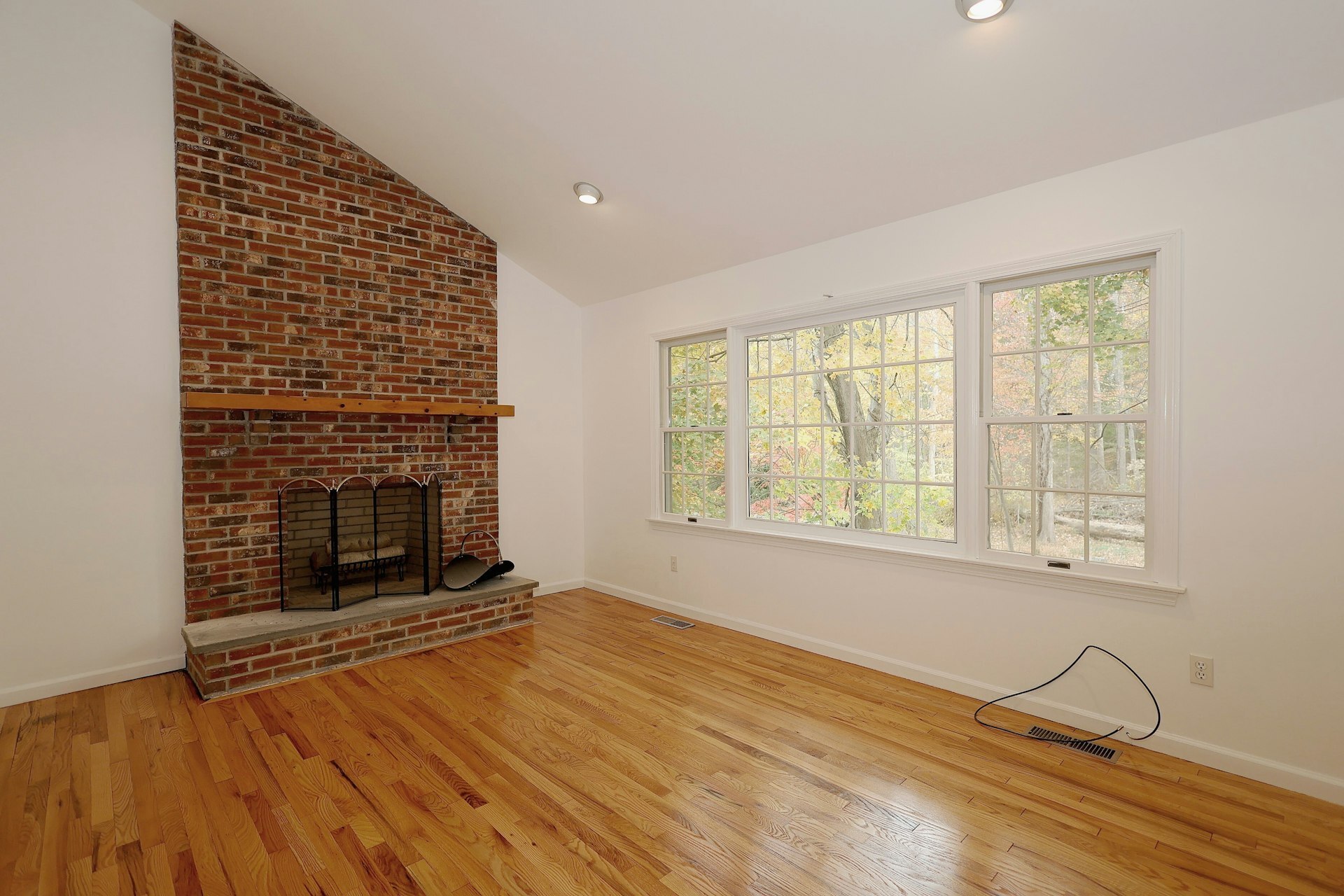 44 Deer Run Road Fairfield, CT 06824 - Photo 33 of 40 a view of an empty room with wooden floor fireplace and a window