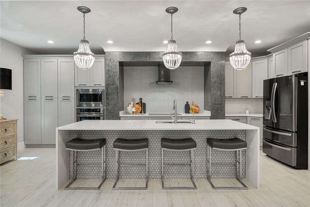 140 Turnberry Road Anderson, SC 29621 - Photo 11 of 44 This modern kitchen offers integrated appliances and a spacious island with sleek pendant lighting.