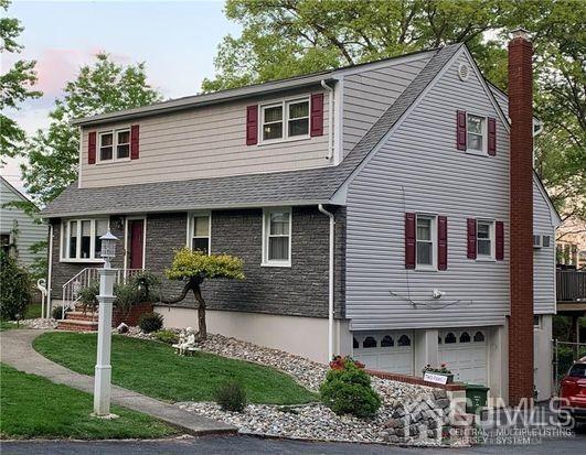 65 Tower Road Edison, NJ 08820 - Photo 1 of 14 a front view of a house with garden