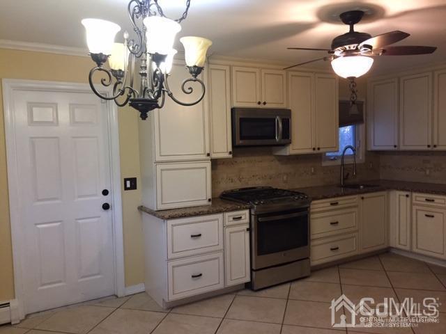 65 Tower Road Edison, NJ 08820 - Photo 13 of 14 a kitchen with a stove oven and a sink