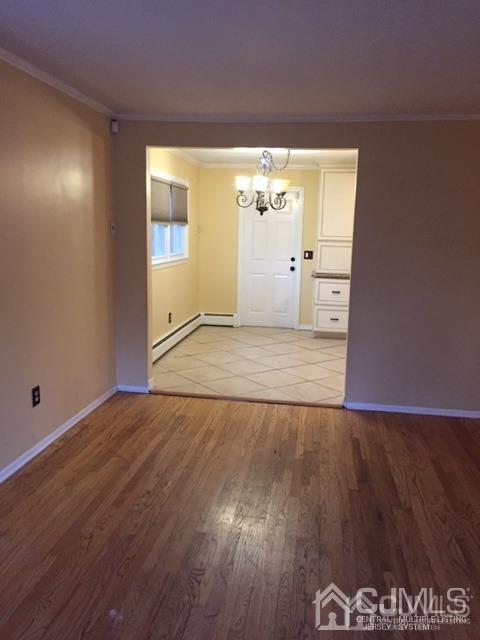 65 Tower Road Edison, NJ 08820 - Photo 14 of 14 an empty room with wooden floor and windows