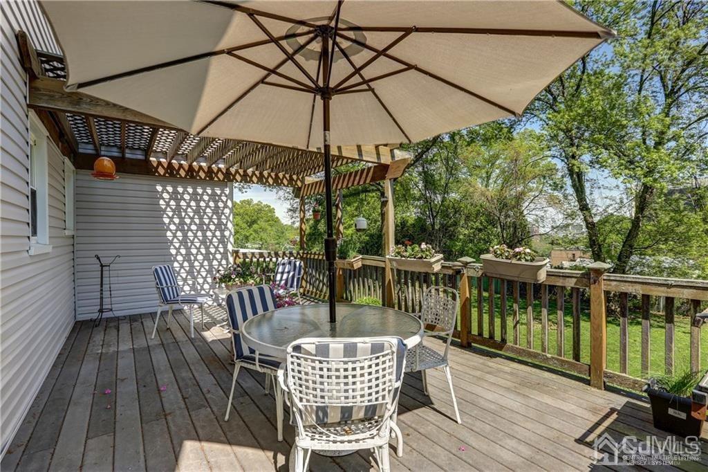 65 Tower Road Edison, NJ 08820 - Photo 3 of 14 a view of a chair and table on the deck